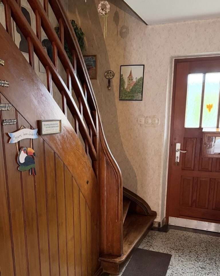 Projekte Blick auf den geschwungenen Startbereich einer historischen Holztreppe im Flur eines alten Bauernhauses vor dem Einbau des Lifts.